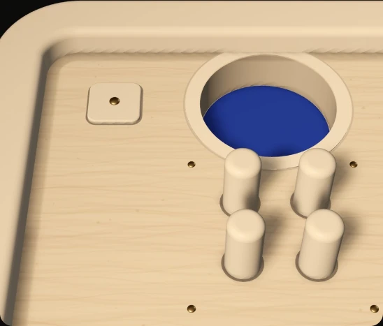 Four round pins standing out of the beech floor beside a hole, with a small square button